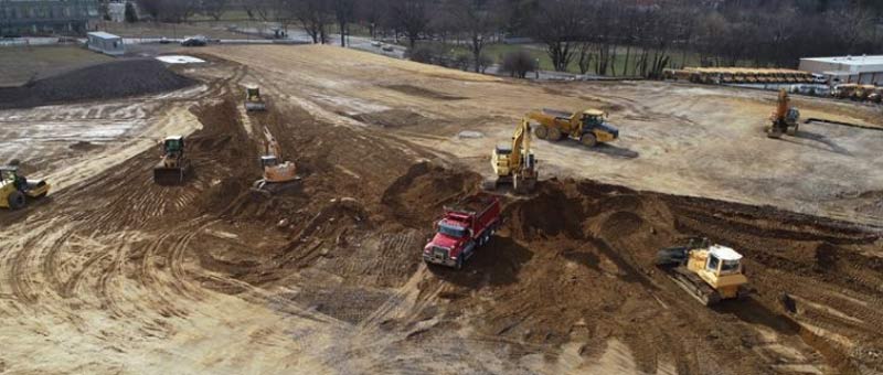 Falcone & Sons trucks doing excavation and earthwork on site.